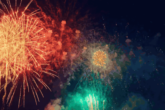 Happy New Year 2027 fireworks GIF — multicolour fireworks in red, gold, green and purple with golden Happy New Year 2027 text